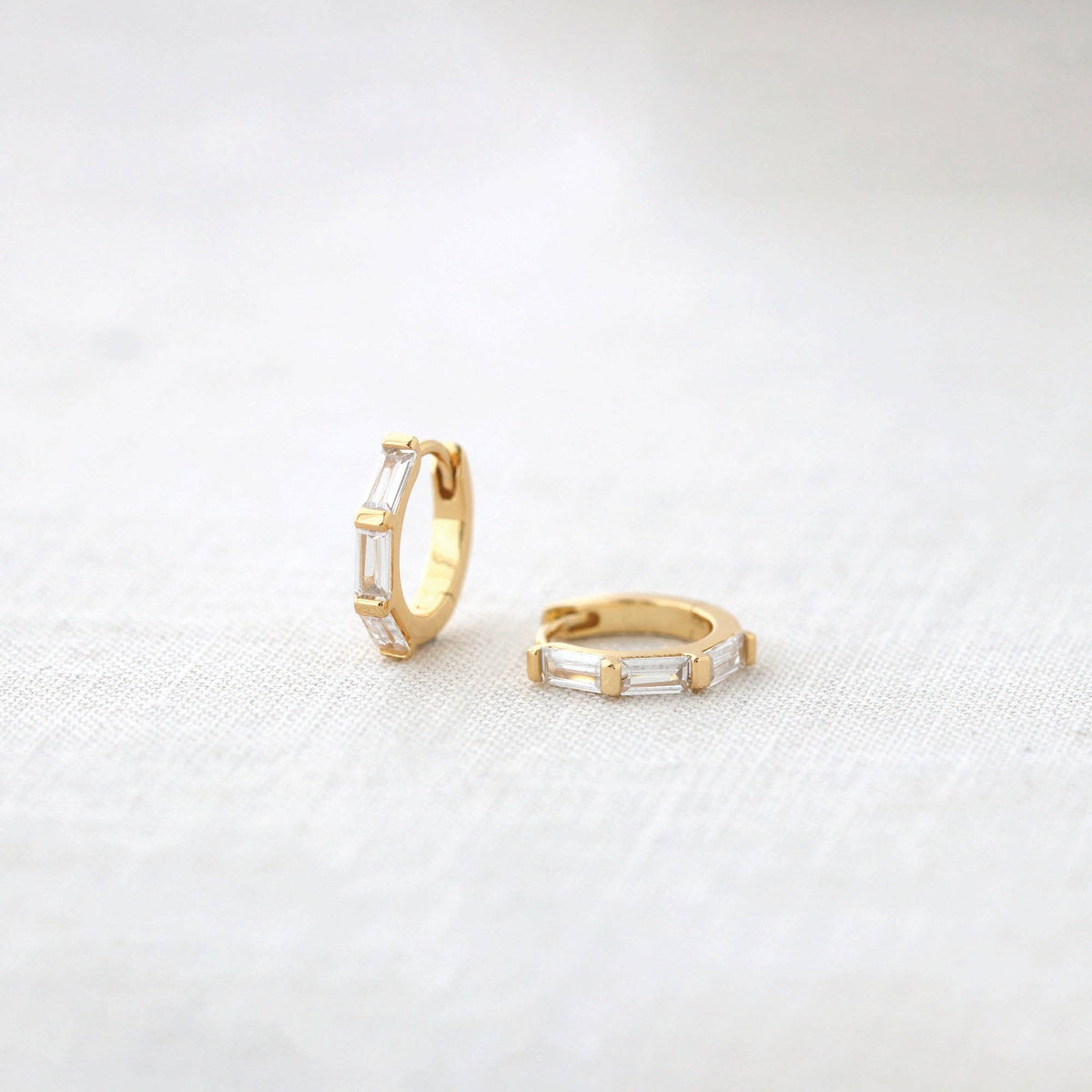 Baguette Huggie Hoop Earrings in gold vermeil on linen