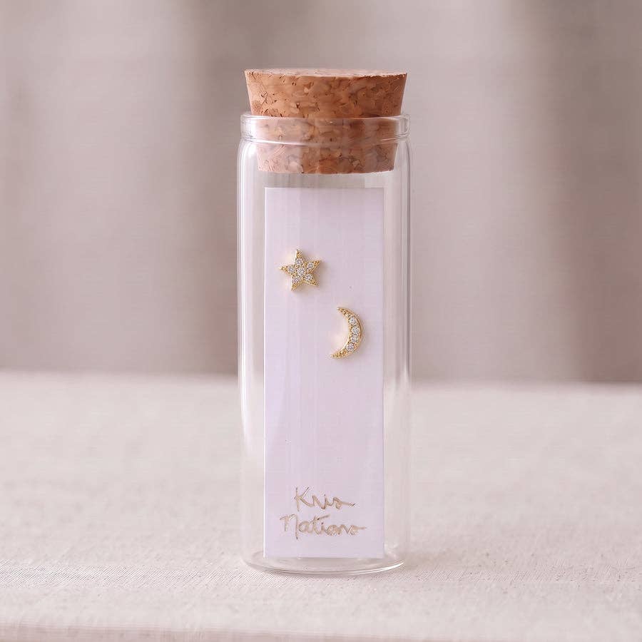 Close view of pave crystals on a gold crescent moon stud