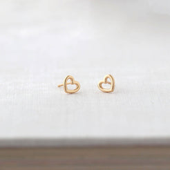 Heart Outline Stud Earrings in gold vermeil laid on linen