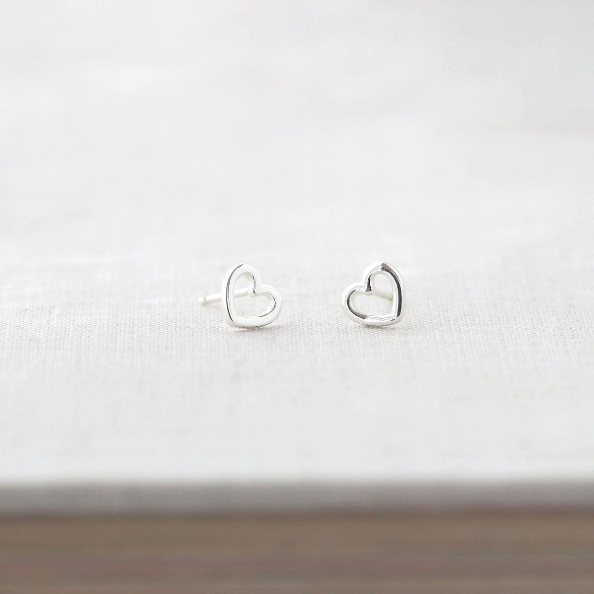 Pair of tiny open hearts shown from the front