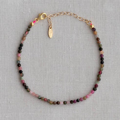 Pink stone bracelet worn on a model's wrist