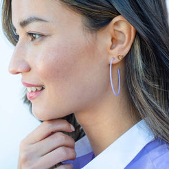 Silver-tone open heart stud worn on the ear