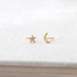 Star and Moon Crystal Stud Earrings in gold vermeil on a white book