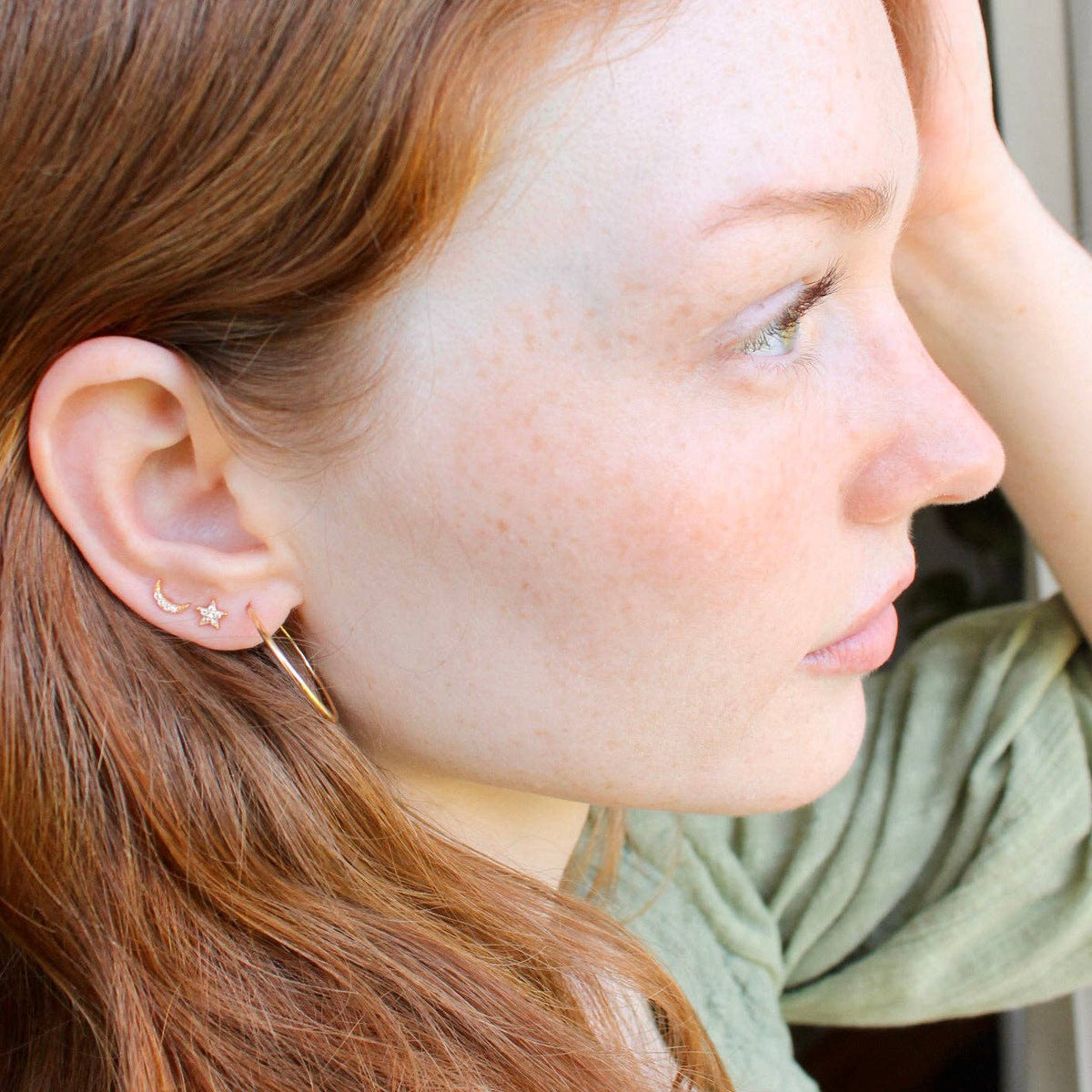 Silver-tone star and crescent studs shown side by side
