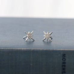Close view of cubic zirconia crystals set in a gold starburst