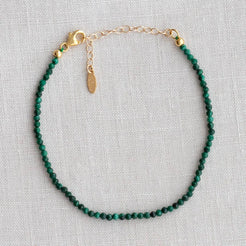 Tourmaline beaded bracelet laid flat on linen
