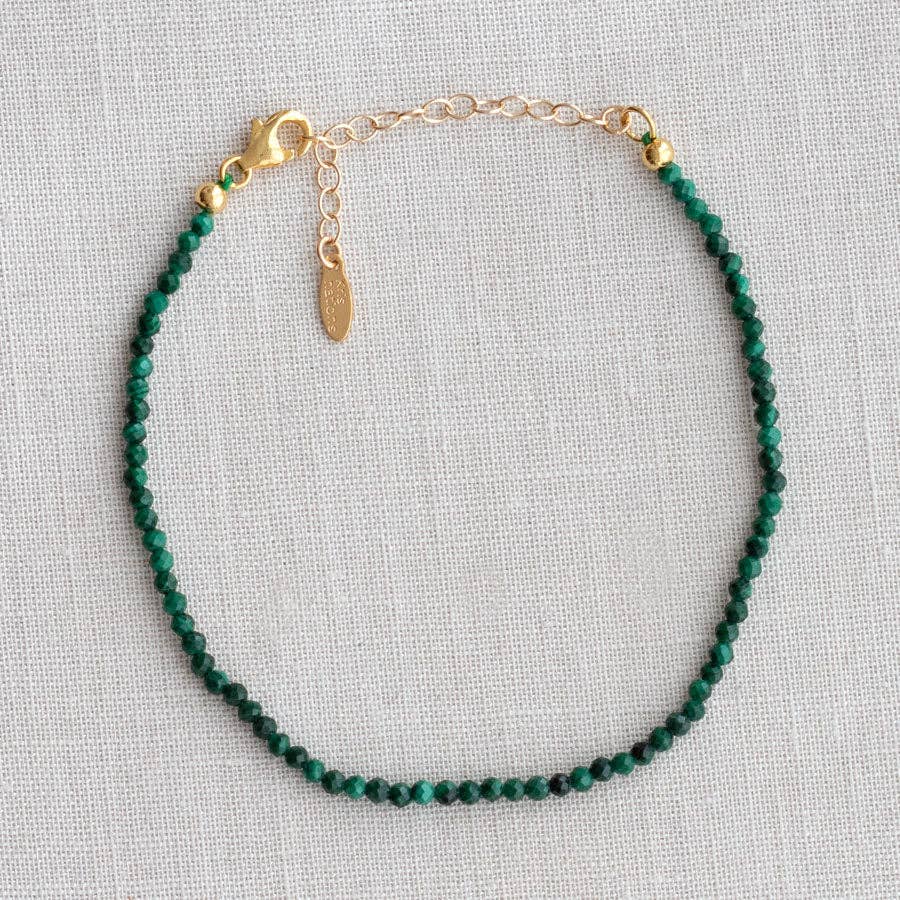 Tourmaline beaded bracelet laid flat on linen